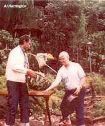 This is at Al's home in Hawaii where they are preparing for a roast. The man with Al Harrington is Joyce's husband. The basket Al has in his hands is one that Al wove himself.